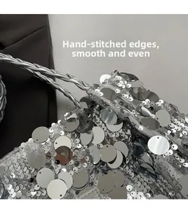 Close-up of silver sequin tote bag with woven leather handle and manual stitching details