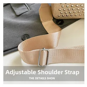 Detail of adjustable nylon shoulder strap with silver metal buckle on a woven bag