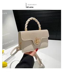 Close-up of beige woven leather bag with gold floral clasp and twisted rope handle