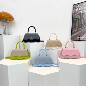 Retro woven crossbody bags set in five colors on geometric plinths with wave-cut flap design