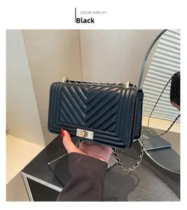 Detail shot of the black chevron quilted leather texture and vintage metal lock closure