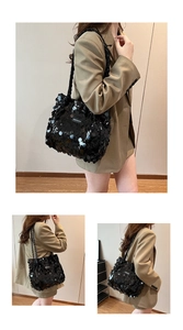 Detailed view of black sequined tote bag with woven straps on a model's shoulder