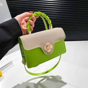 Elegant neon green straw patchwork handbag with golden clover clasp and top handle
