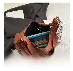 Detail view of large brown faux leather tote bag showing spacious interior compartment