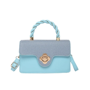 Elegant blue patchwork handbag with floral metal clasp and twisted top handle design