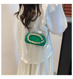 Fashionable green oval pillow bag with gold metal C-buckle and chain strap detail