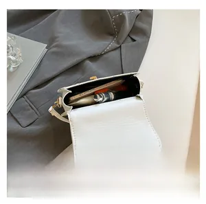Interior view showing the large capacity of the white saddle bag with lace floral embroidery