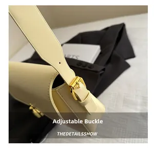 Detail of adjustable golden metal buckle on beige leather shoulder strap for women bag