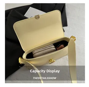 Interior view of cream shoulder bag showing storage for wallet and lipstick items