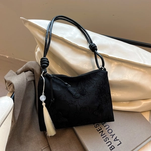 Black vintage shoulder bag with butterfly embroidery and elegant silk tassel detail