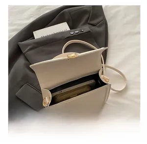 Internal capacity of white PU leather crossbody bag showing space for phone and wallet