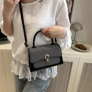 Contrast grey tweed and black leather crossbody bag with gold horseshoe buckle