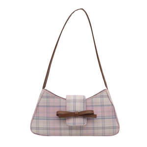 Pink and light blue plaid underarm bag with a brown leather bow and shoulder strap