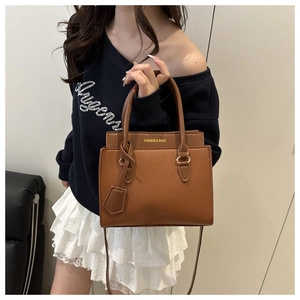 Brown lychee grain tote bag with FASHION & BAGS gold text and detachable strap