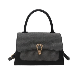 Minimalist colorblock handbag with woven flap and gold metal buckle on white background