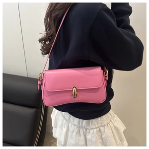 Chic pink leather shoulder bag with gold clasp shown with casual black and white outfit