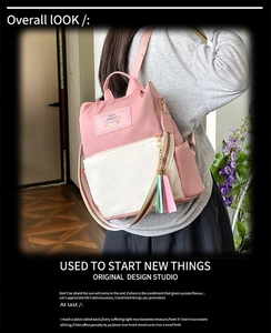 Pink and white Oxford fabric backpack featuring striped straps and tassel charm in detail