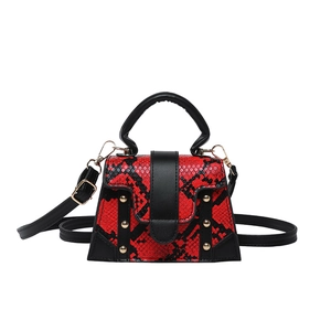 Snake pattern trapezoid handbag with gold rivet accents and adjustable black strap