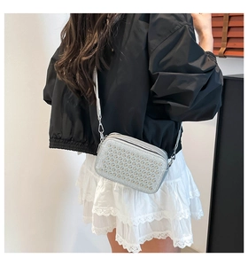 Silver glossy square crossbody bag with metallic studs and dual zipper detail