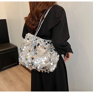 Detail view of shimmering silver sequins and fashion label on the stylish woven tote bag