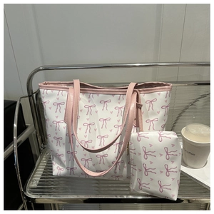 Detail of white tote bag set with pink bow print and matching small zipper pouch