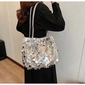 Detail of silver sequin tote bag with Fashion & Bags leather patch and woven shoulder strap