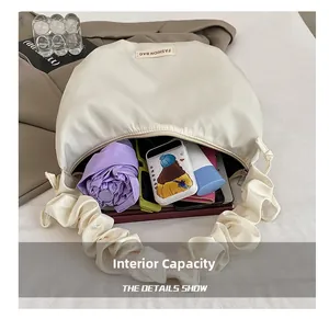 Detail view of large capacity interior for the pleated oxford hobo bag with essentials