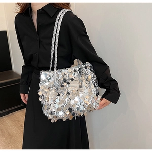 Detail of silver sequin tote bag showing metallic glint and woven shoulder strap
