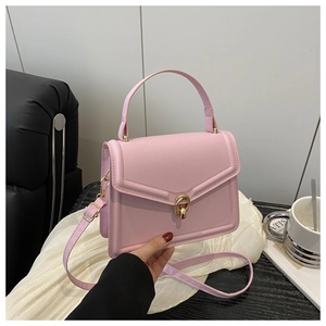 Detailed shot of pink PU leather handbag with golden ring lock and fine stitching