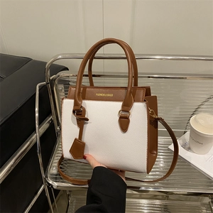 Contrast color large tote bag in white and brown leather shown in a lifestyle setting