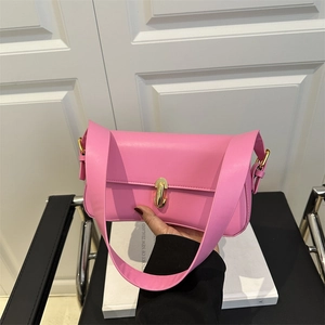 Pink faux leather underarm bag with gold metal twist lock and wide adjustable strap