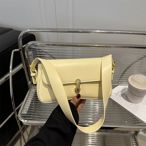 Chic beige underarm bag for women with golden capsule clasp and wide shoulder strap