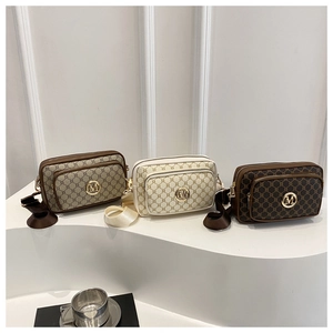 Detailed display of three vintage crossbody bags with geometric patterns and broad straps