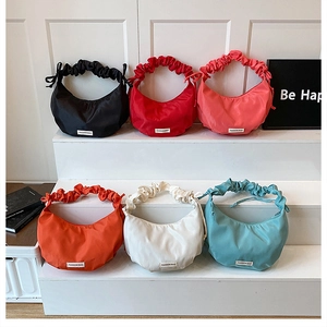 Selection of colorful nylon hobo bags with ruffled straps and fashion bag label detail