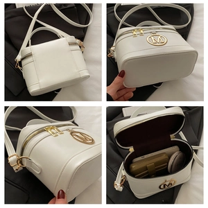 Detailed views of white leather box bag with golden M logo and spacious inner compartment