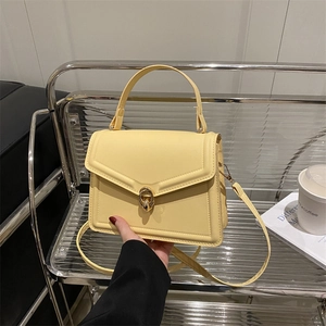 Elegant pale yellow structured handbag with gold round buckle for office wear