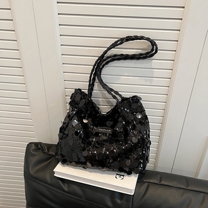 Fashionable black sequin tote bag with woven leather handle on white background