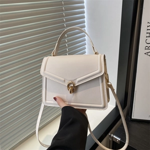 Elegant white square handbag with geometric stitching and gold metal twist lock