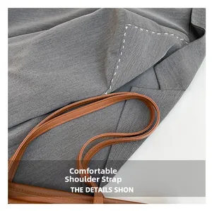 Close-up of the durable brown leather shoulder strap with reinforced stitching details