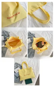 Detail view of large yellow canvas tote bag showing interior capacity and red letter print