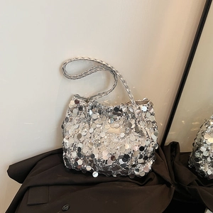 Chic silver sequin tote bag with woven shoulder strap styled on black blazer