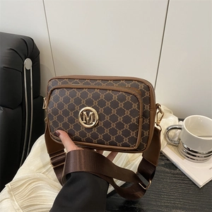 Vintage patterned crossbody camera bag with gold M logo and wide nylon strap