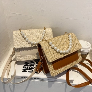 Straw woven flap crossbody bag with pearl handle and leather shoulder strap in beige