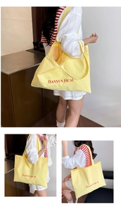 Detailed views of a yellow large capacity nylon tote bag with red embroidered text