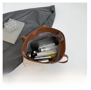 Interior view showing the large capacity of the vintage tote bag with tablet and cosmetics