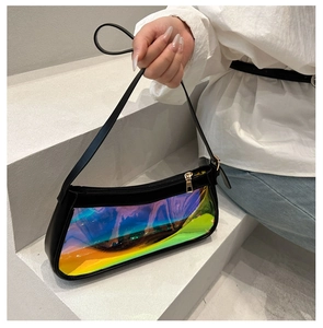 Detailed shot of holographic transparent panel and black leather trim on a shoulder bag