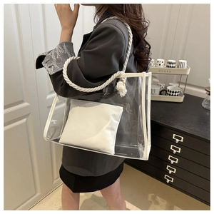 Detailed view of transparent PVC tote bag with white leather pouch and cotton rope handles