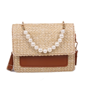 Fashionable straw woven flap crossbody bag with pearl handle and brown leather trim