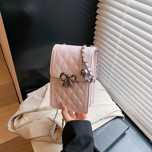 Pink quilted crossbody phone bag with silver bow accent and chain strap for women