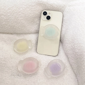 Frosted translucent fish-shaped phone pop sockets in pastel mint, yellow, pink, and purple